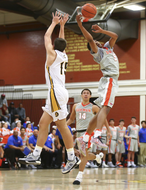 Clark’s James Bridges (15) and Bishop Gorman’s Chuck O’Bannon (5) go up fo ...