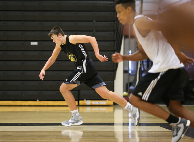 Clark guard James Bridges, center, runs a drill during practice at Ed W. Clark High School i ...