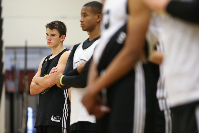 Clark guard James Bridges, far left, listens to coach Colin Darfour during practice at Ed W. ...