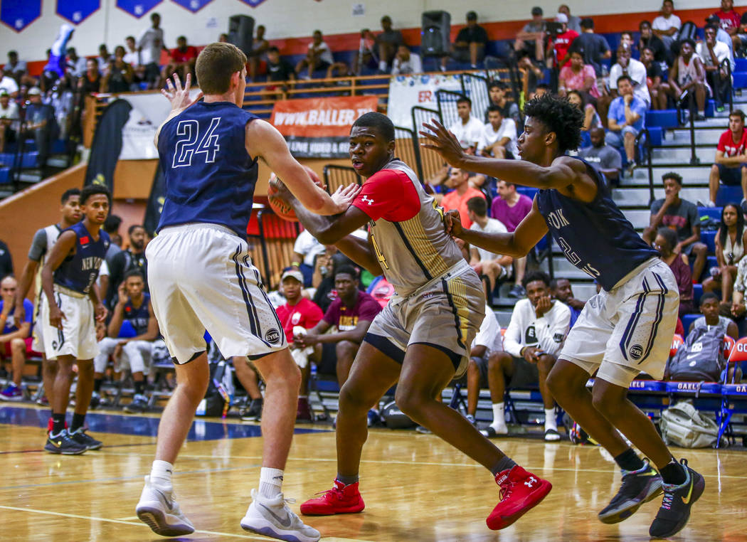 Team Thad’s Javian Fleming, center, defends the ball against New York defenders Sloan ...