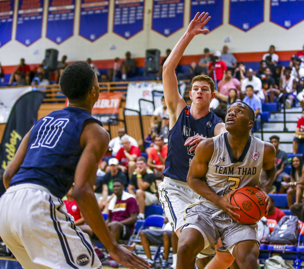 Team Thad’s Tavin Lovan (3) looks for a layup opportunity against New York defenders A ...