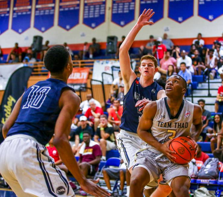 Team Thad’s Tavin Lovan (3) looks for a layup opportunity against New York defenders A ...