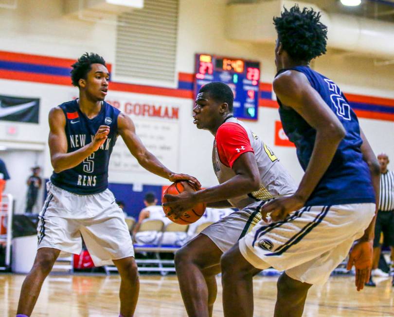 Team Thad’s Javian Fleming , center, defends the ball against New York defenders Bryce ...