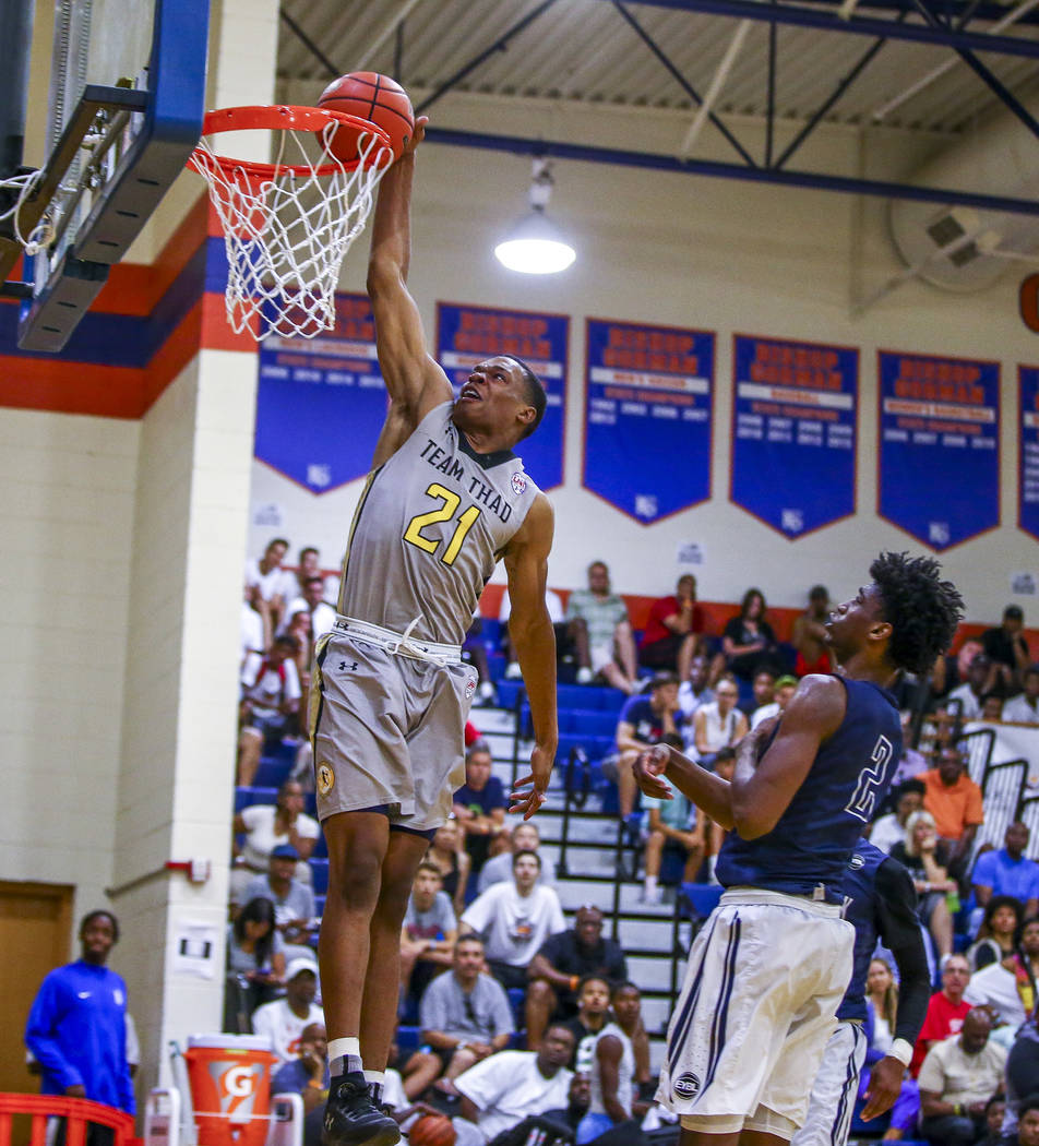 Team Thad’s Robert Woodard II (21) makes a dunk against New York’s Khalid Moore ...