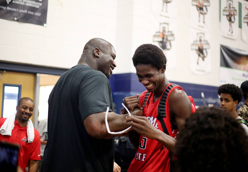 California Supreme assistant coach Shaquille O’Neal congratulates Fred Odhiambo, 15, a ...