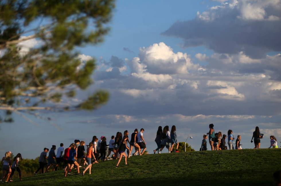 People gather for a vigil in memory of Haylei Hughes, a former Cimarron-Memorial student-ath ...