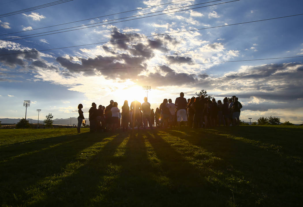 People gather during a vigil for Haylei Hughes, a former Cimarron-Memorial student-athlete, ...