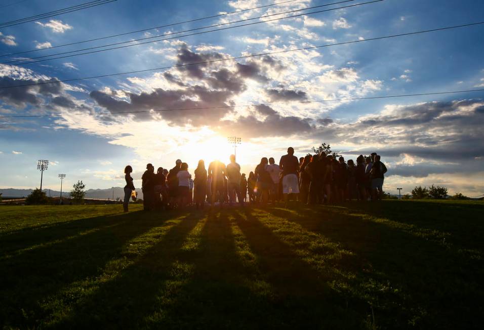 People gather during a vigil for Haylei Hughes, a former Cimarron-Memorial student-athlete, ...