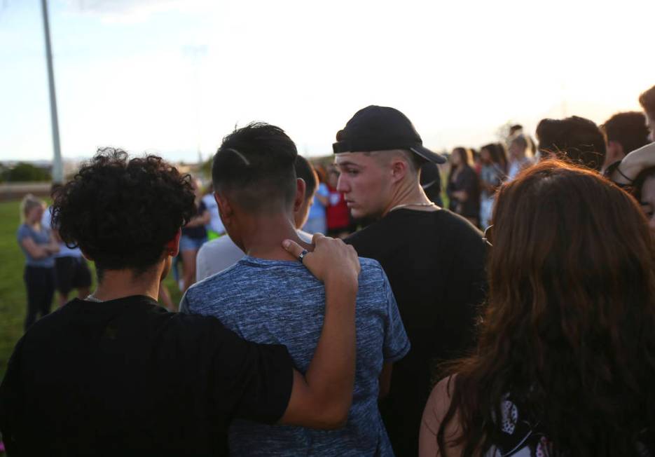 People gather during a vigil for Haylei Hughes, a former Cimarron-Memorial student-athlete, ...