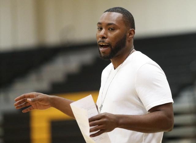 Clark High School basketball head coach Colin Darfour talks to his team during practice at E ...