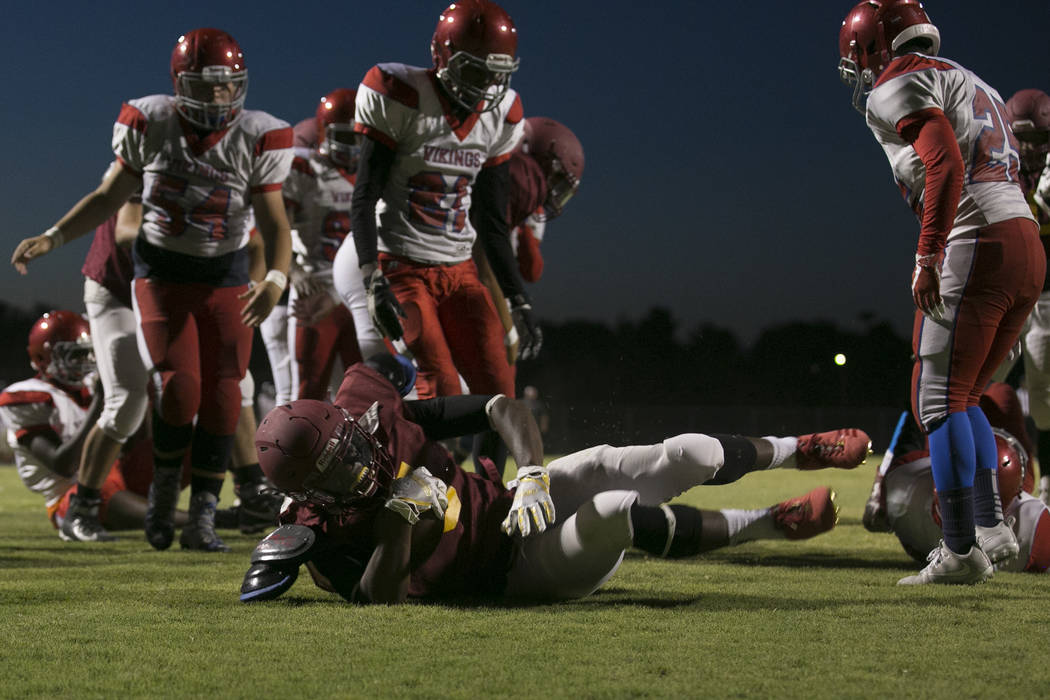 Del Sol senior Taariq Flowers brings the ball to the end zone during a three-team scrimmage ...