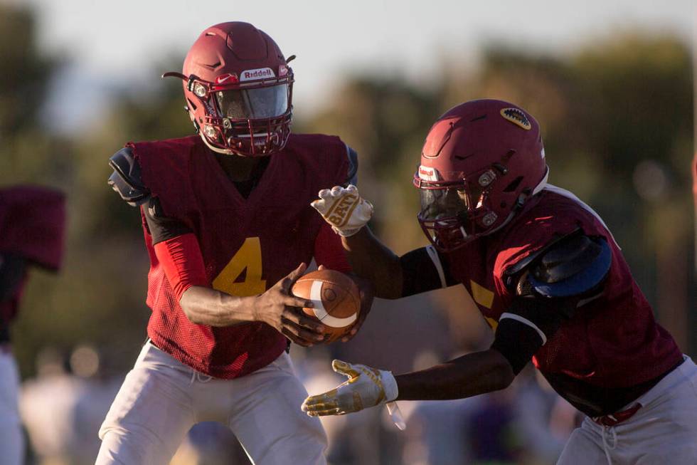 Del Sol sophomore Maalik Flowers, left, hands the ball off to his brother and teammate Taari ...