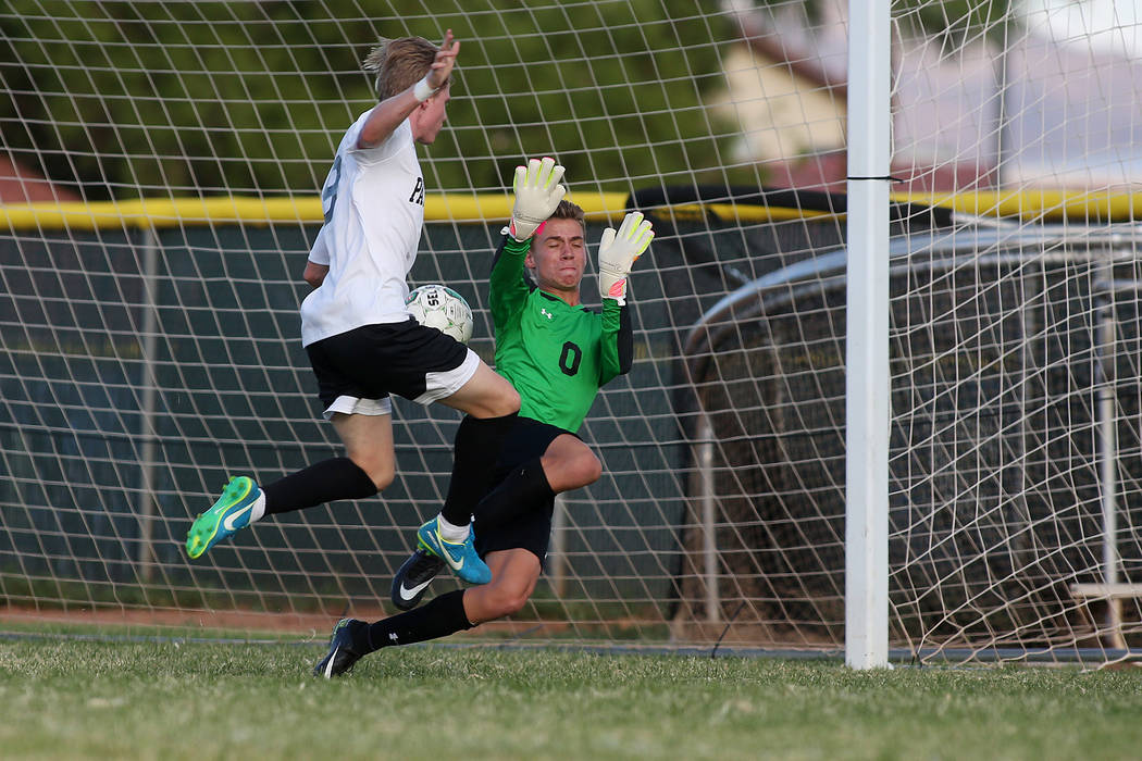 Faith Lutheran goalie Landon Amick attempts to save the ball as Palo Verde player Presten Ma ...