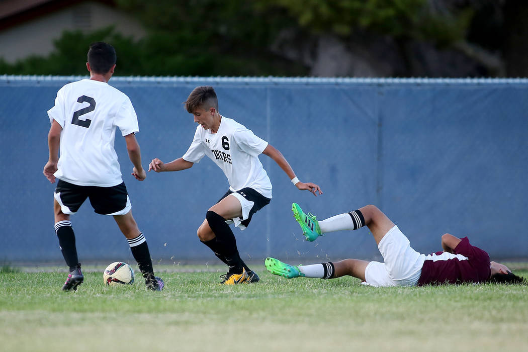 Palo Verde players Atakan Saricayir, left, and Antonio Gomez take the ball as Faith Lutheran ...