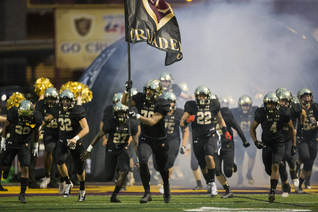 Faith Lutheran takes the field for their football game against Green Valley at Faith Luthera ...