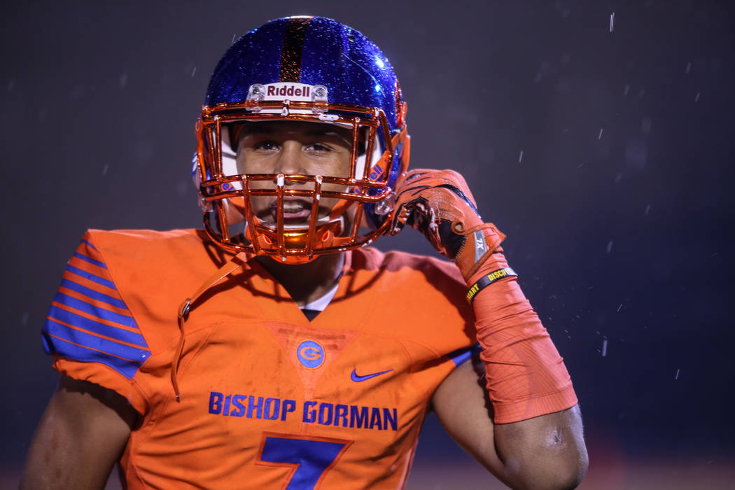 Bishop Gorman’s Jordan Lee (7) clips his chin strap during a game against Miami Centra ...