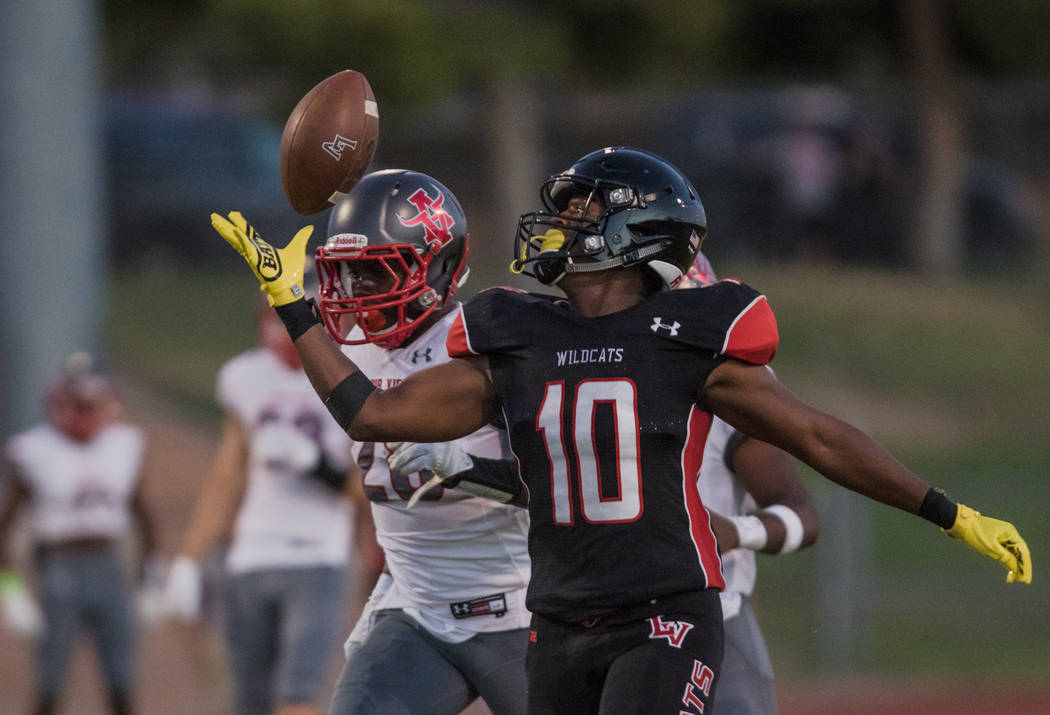 Las Vegas High School Wildcats running back Elijah Hicks (10) prepares for the catch as Arbo ...