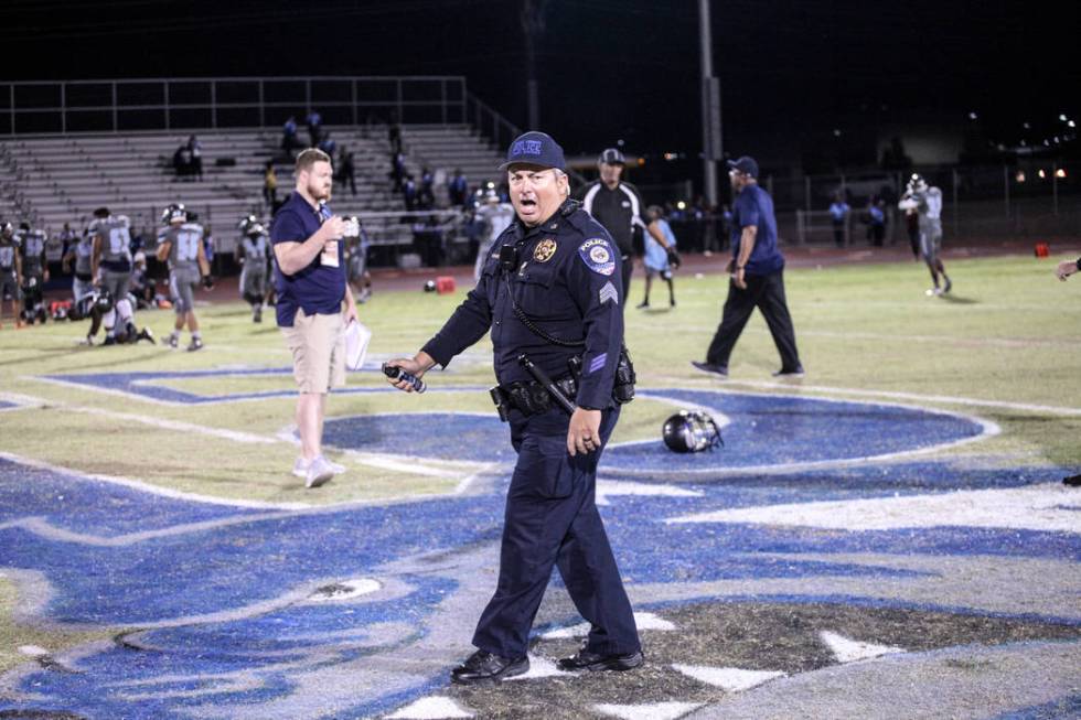 A police officer holds pepper spray after dispersing a brawl between Canyon Springs and Basi ...