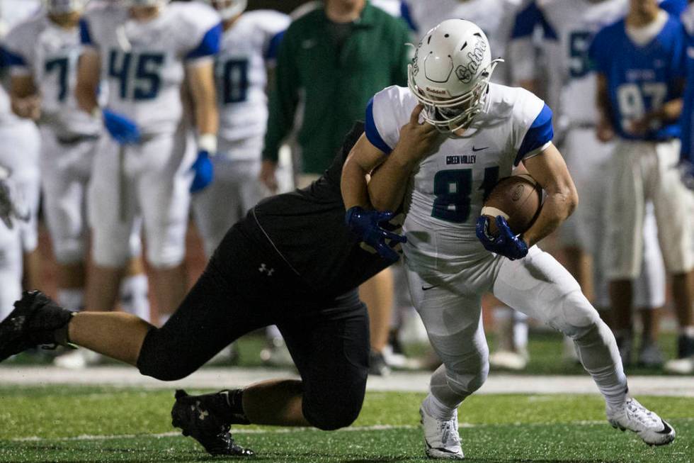 Faith Lutheran’s Jacob Freel (72) tackles Green Valley’s Reyden Morett (81) in t ...