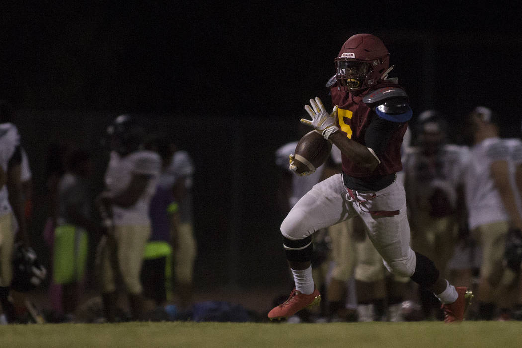 Del Sol senior Taariq Flowers runs the ball during a three-team scrimmage at Del Sol High Sc ...