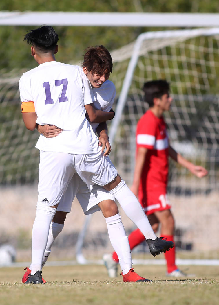 Sunrise Mountain player Bryan Garcia (17) congratulates teammate Felipe Lucero (11) on a goa ...