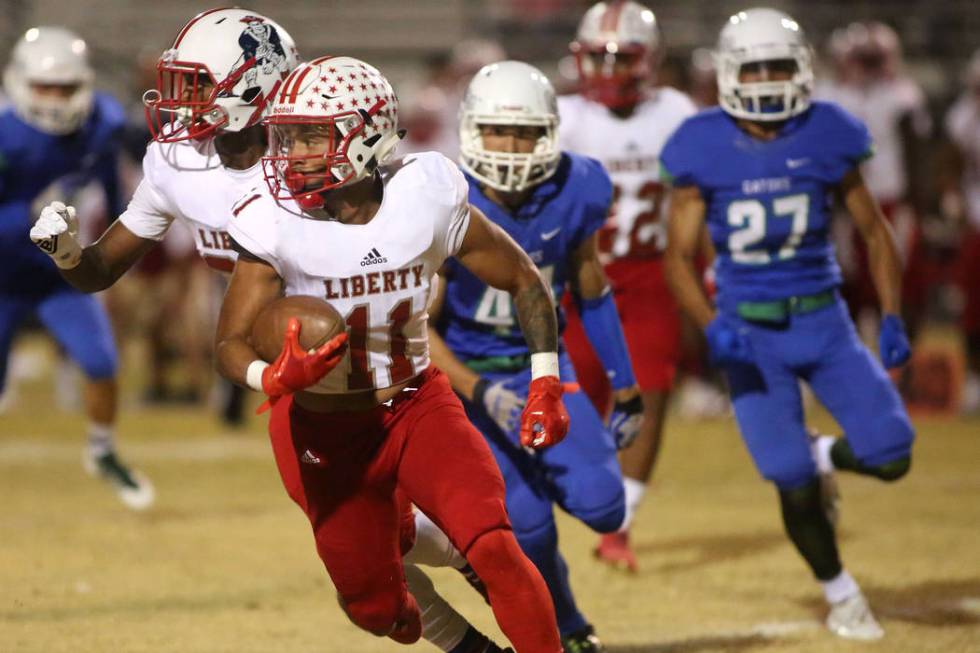 Liberty player Jake Dedeaux (11) runs the ball during the first half a game against Green Va ...