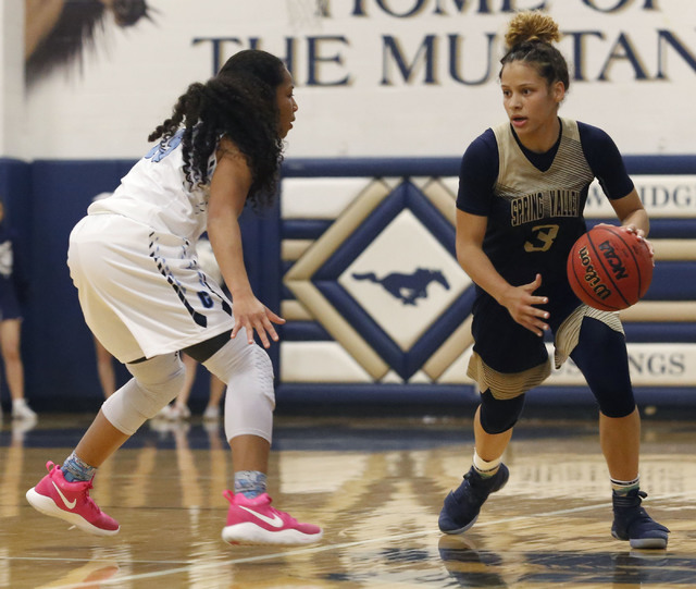 Spring Valley’s Essence Booker (3) drives down the court during the first half of a Cl ...