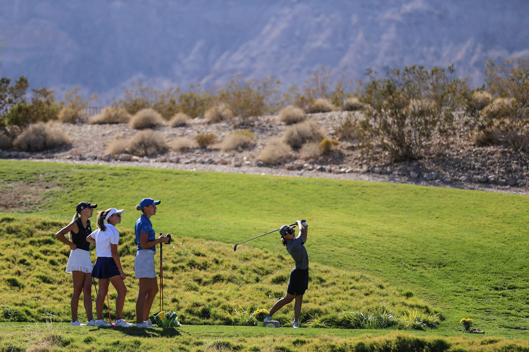 Clark’s Riana Mission swings during the Class 4A Sunrise and Sunset Region girls golf ...