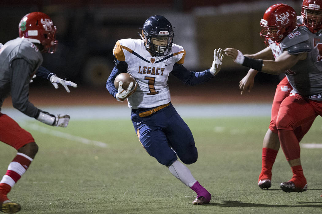 Legacy’s Aubrey Washington (1) runs the ball against Arbor View in the football game a ...