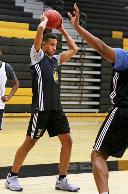 Clark High School senior Greg Foster passes the ball during basketball practice at Clark Hig ...