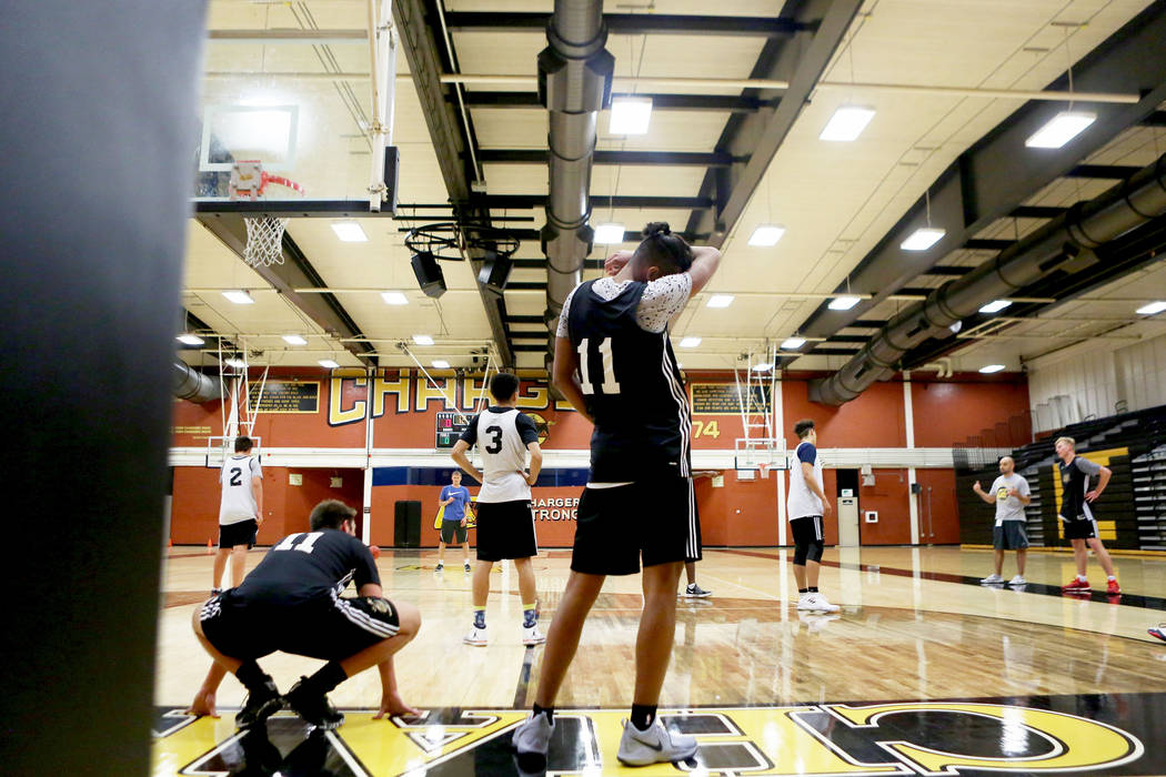 Clark High School senior Greg Foster, center, wipes his face during basketball practice at C ...