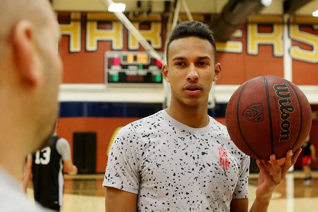 Clark High School senior Greg Foster speaks with coach Chad Beeten during basketball practic ...