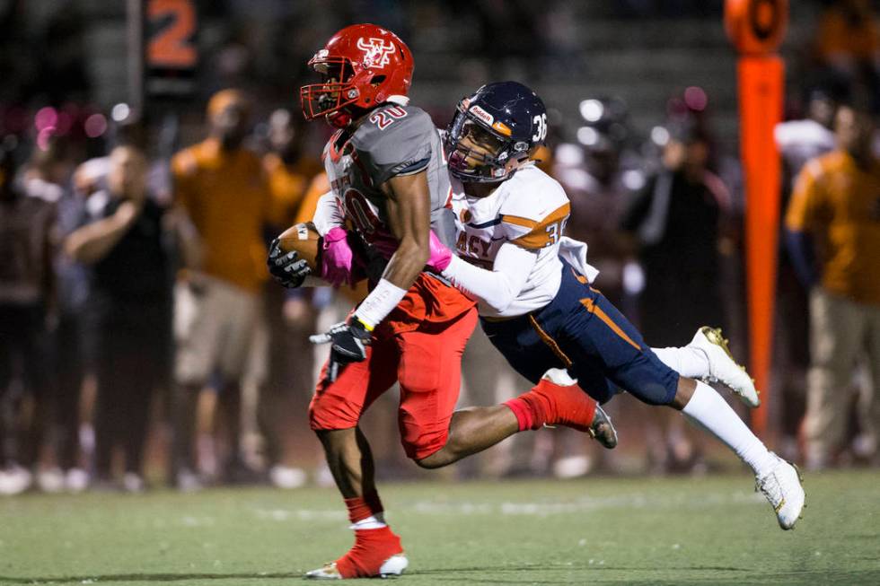 Arbor View’s Jaquari Hannie (20) runs the ball against Legacy’s Amorey Foster ( ...