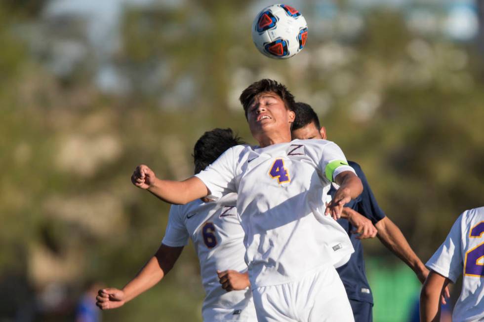 Durango’s Gael Delangel-Parra (4) leaps for the ball in the playoff soccer game agains ...