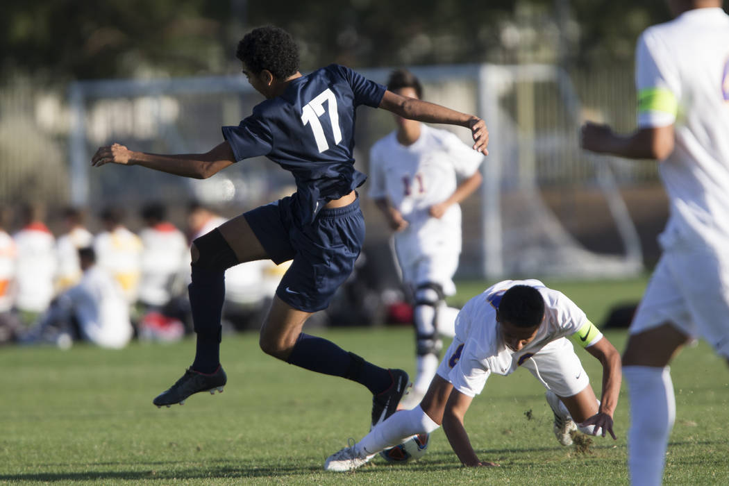 Durango’s Erick Martinez-Rodriguez (8) slides for the ball against Legacy’s Rand ...