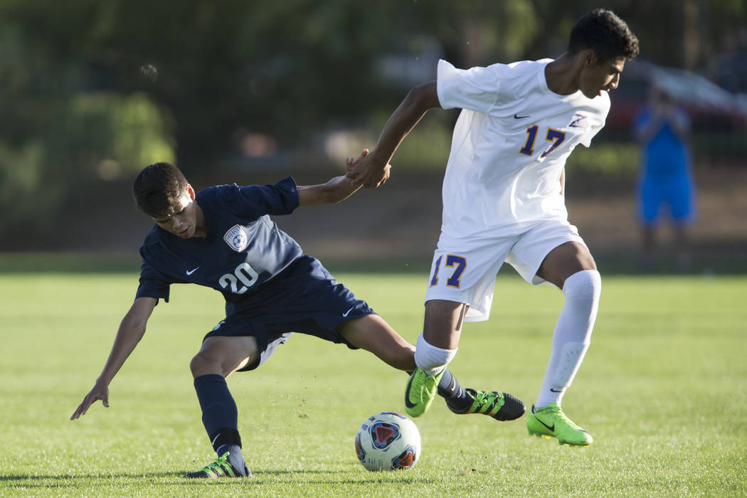 Legacy’s Aalan Rosales (20) fights for ball procession against Durango’s Marcos ...