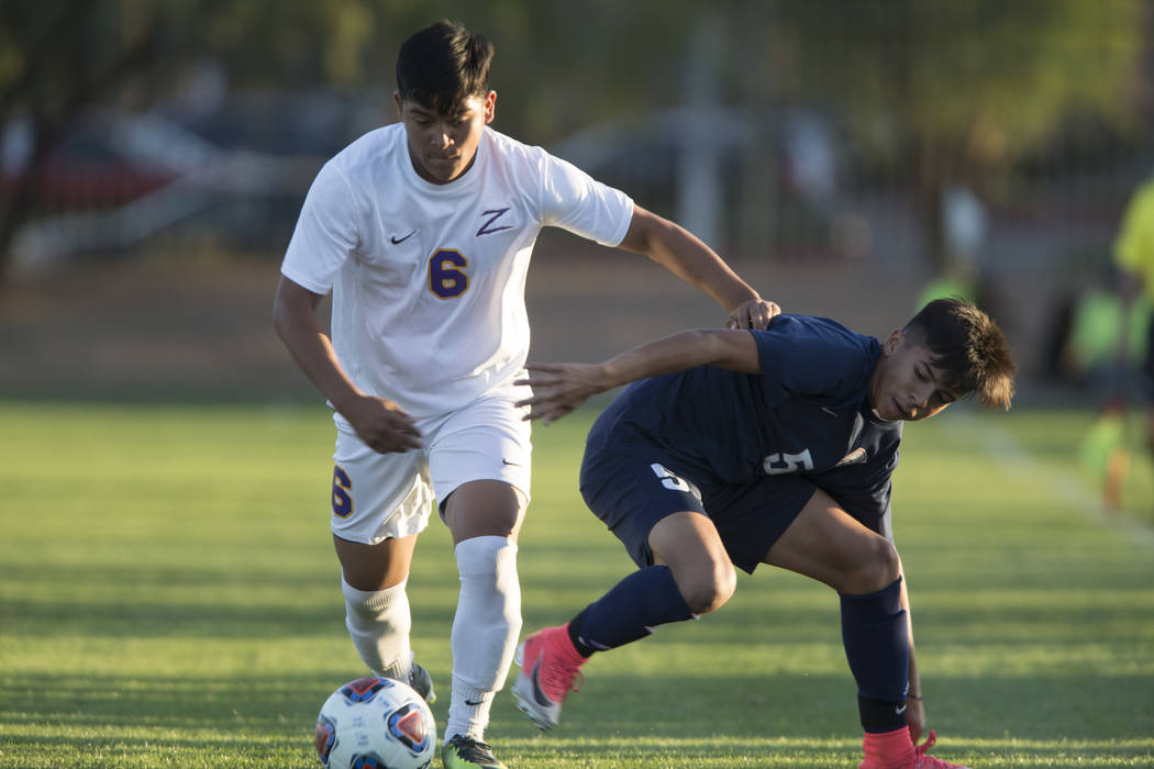 Durango’s Bryan Nava (6) runs by Legacy’s Jesus Cruz (5) in the playoff soccer g ...