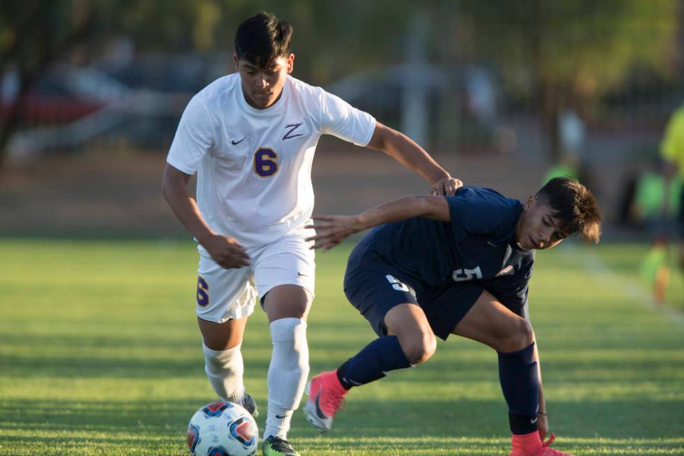 Durango’s Bryan Nava (6) runs by Legacy’s Jesus Cruz (5) in the playoff soccer g ...