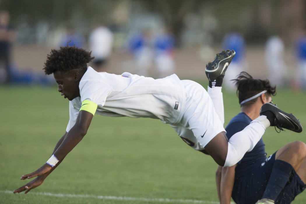 Durango’s Mihreteab Tesfamariam (10) is tackled in the playoff soccer game against Leg ...