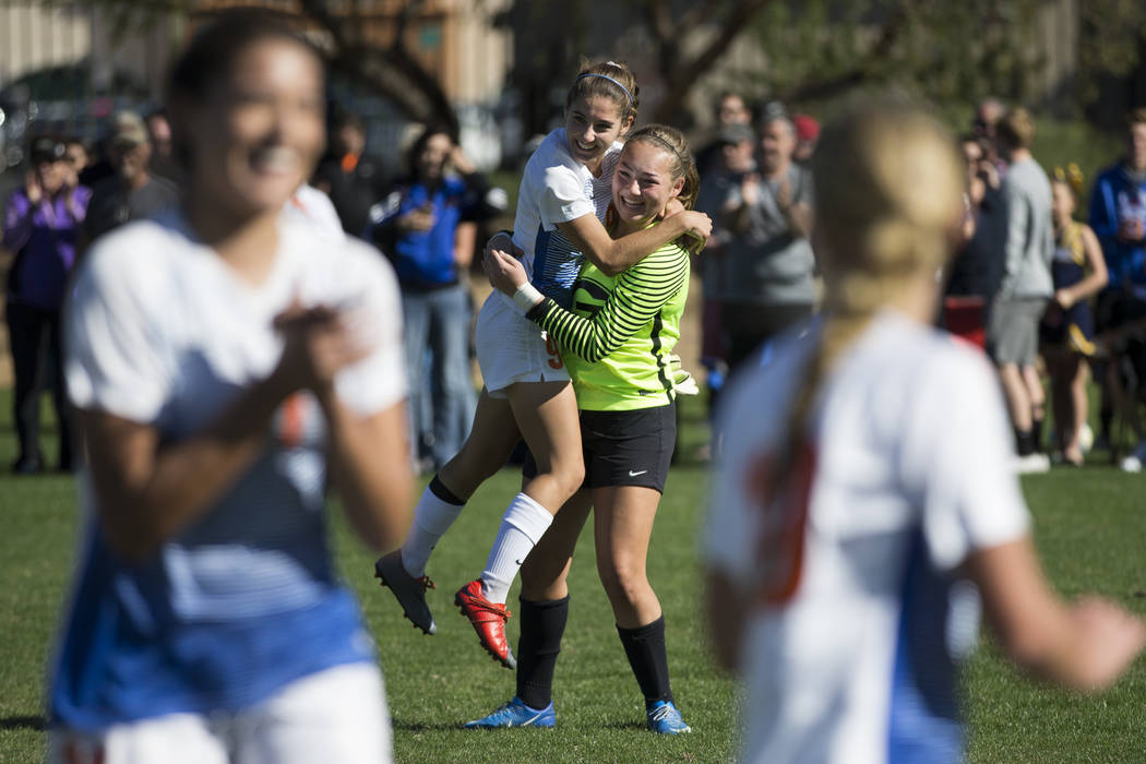 Bishop Gorman players Jaden Terrana (1), left, and Hannah Lee (27), celebrate their victory ...