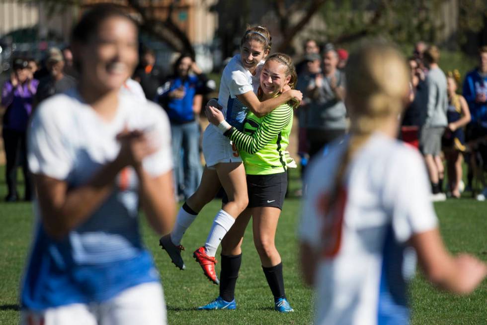 Bishop Gorman players Jaden Terrana (1), left, and Hannah Lee (27), celebrate their victory ...