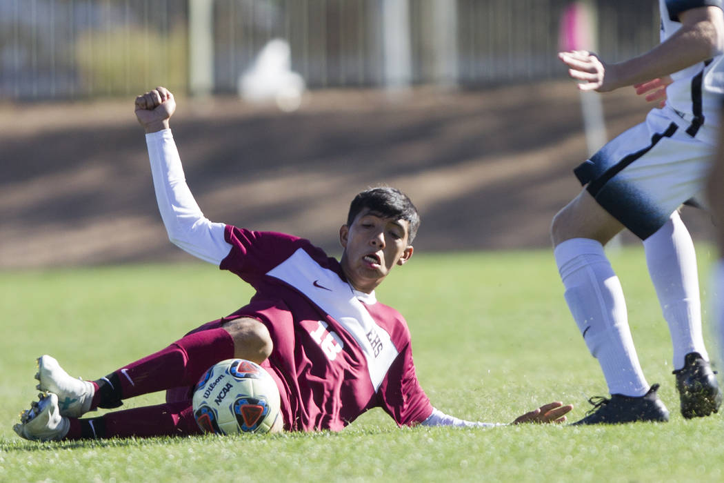 Eldorado’s Cipriano Rodriguez (18) slides for the ball against Coronado in the Sunrise ...