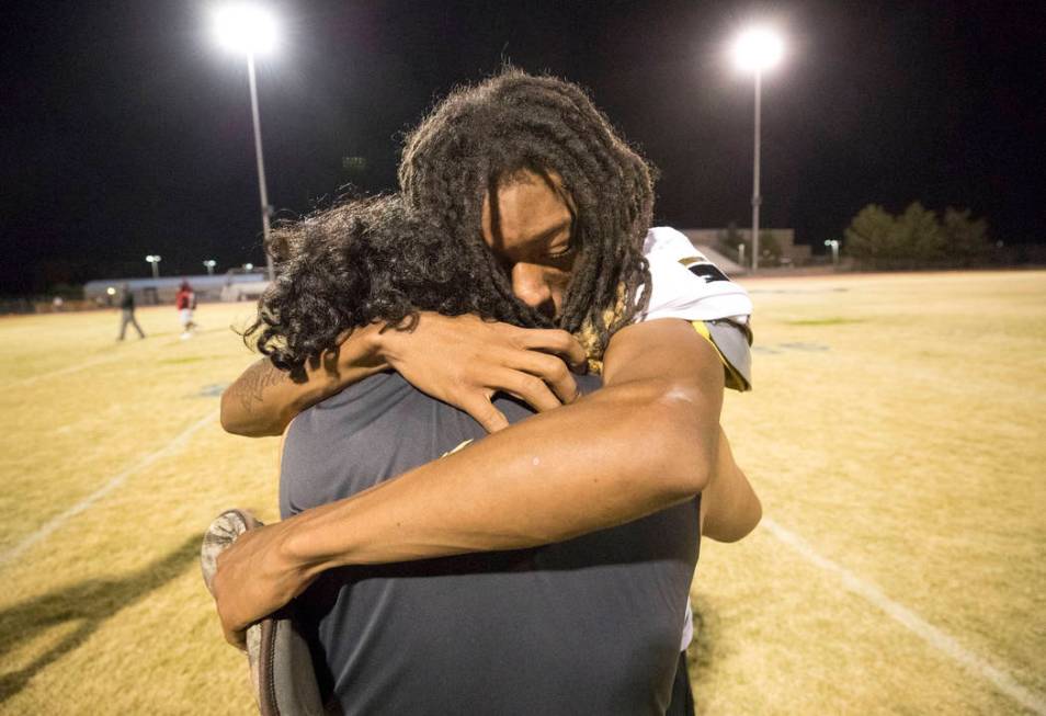 Sunrise Mountain linebacker Gabriel Razo, foreground, consoles running back Trayvon Ward aft ...