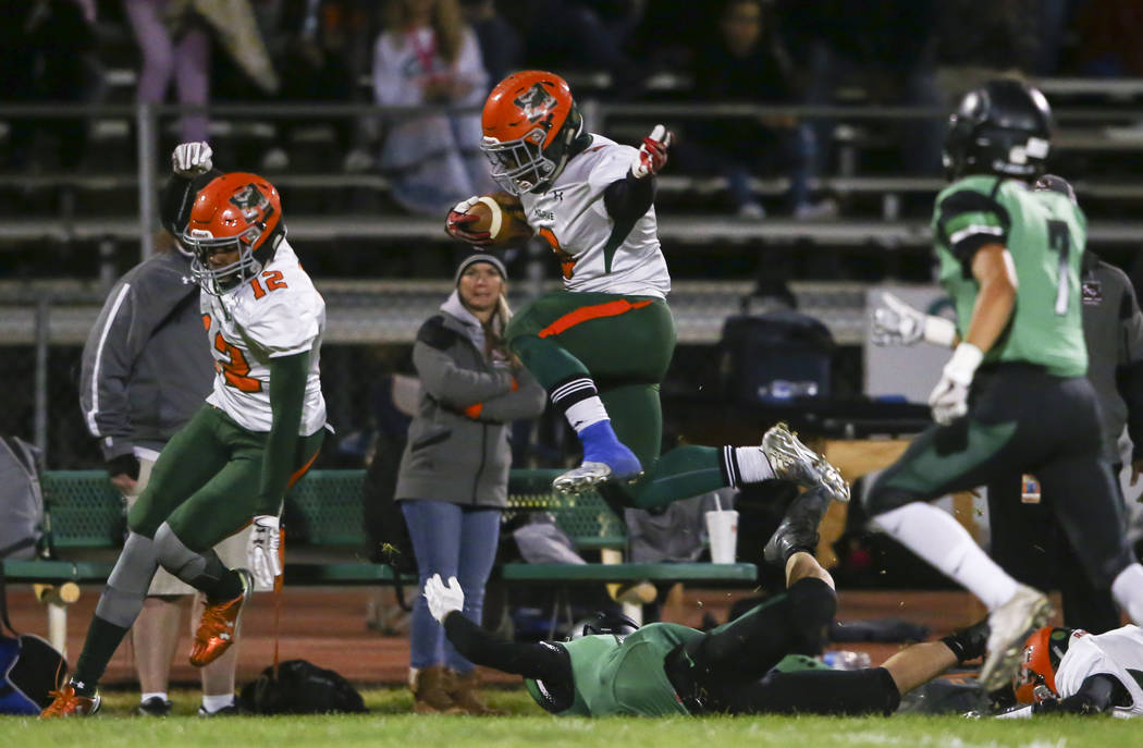 Mojave’s Tawee Walker (3) leaps over a Virgin Valley player during the Class 3A state ...