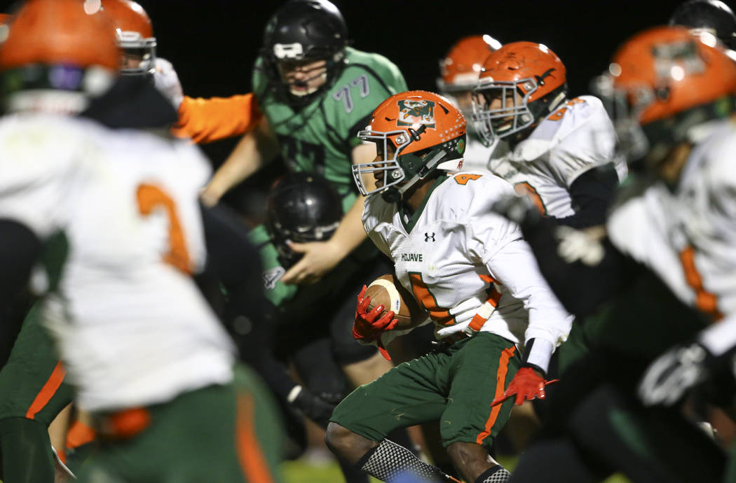 Mojave’s Quincy Smith (4) moves the ball against Virgin Valley during the Class 3A sta ...