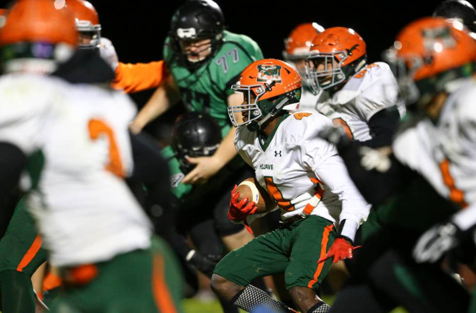 Mojave’s Quincy Smith (4) moves the ball against Virgin Valley during the Class 3A sta ...