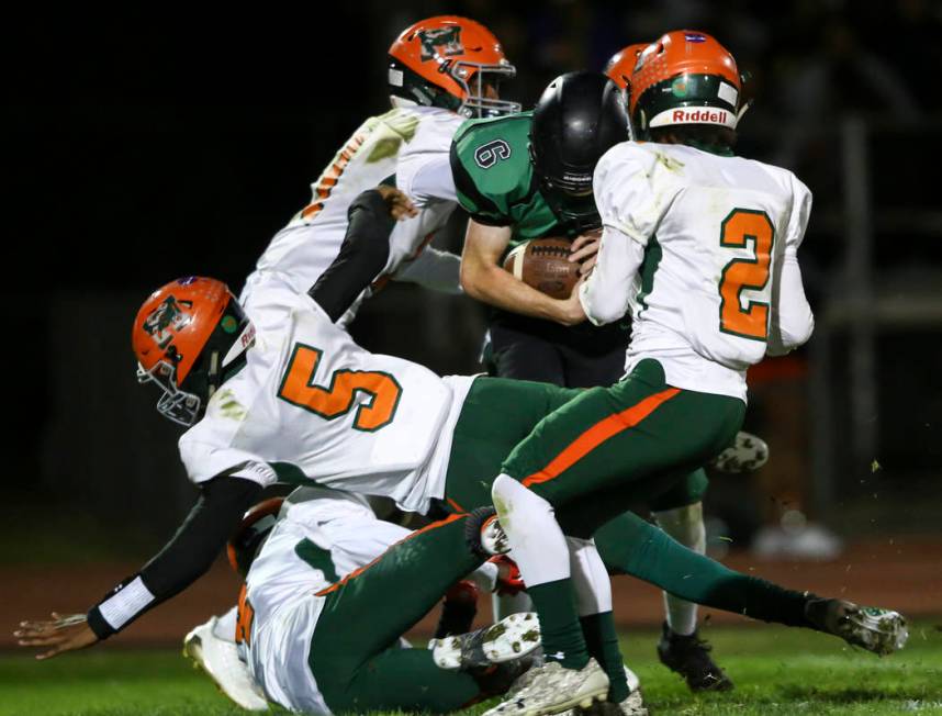 Virgin Valley’s Cade Anderson (6) gets tackled by Mojave players during the Class 3A s ...