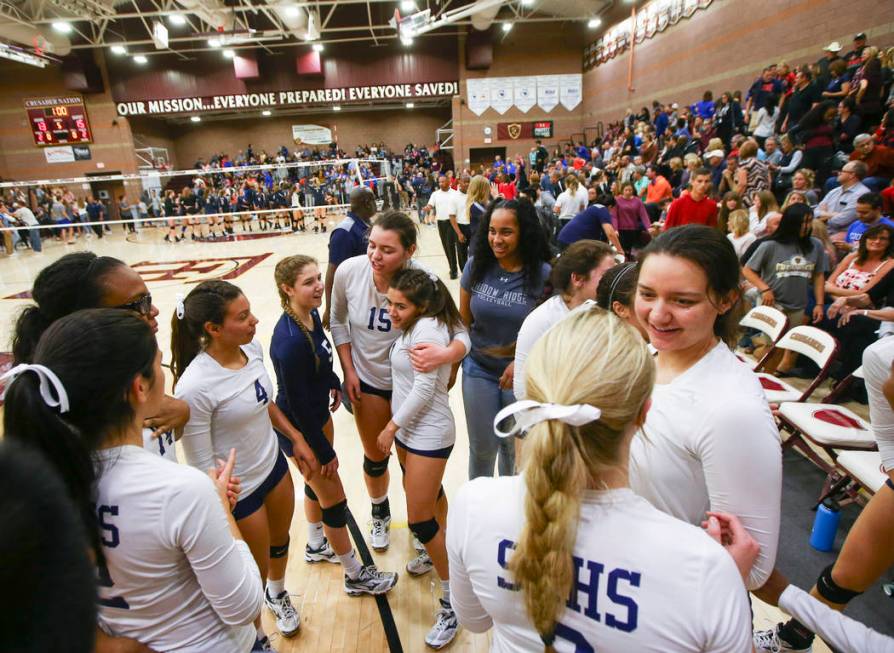 Shadow Ridge players celebrate after defeating Coronado in the Class 4A state volleyball gam ...