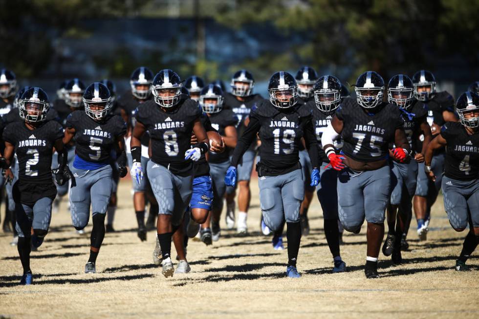 Desert Pines runs onto the field before the start of the Class 3A State football game agains ...