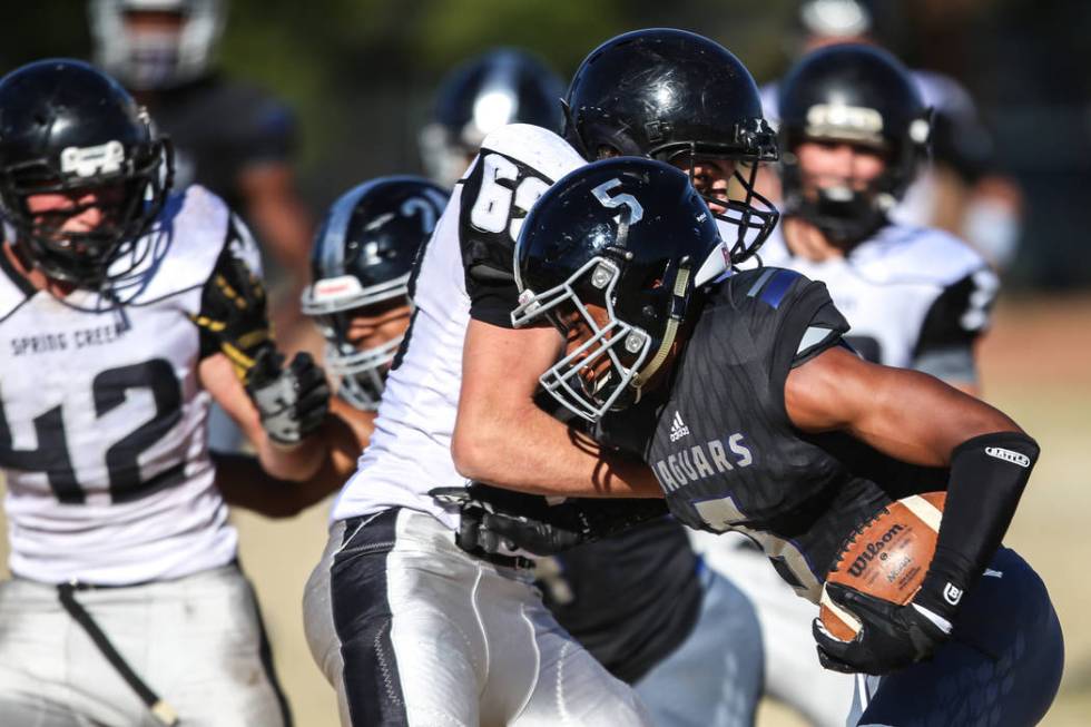 Desert Pines’ Jordan Howden (5) runs the ball against Spring Creek during the first qu ...